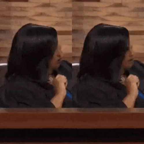 Woman with Long Black Hair Sitting at Table
