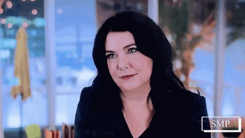 Woman With Long Black Hair Smiling At Camera GIF