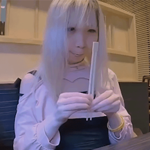 Woman With Long Blonde Hair Holding Chopsticks