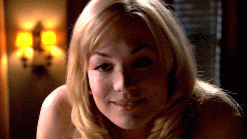 Woman with Long Blonde Hair Smiling at Man