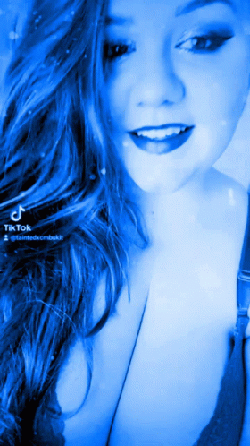 Woman With Long Blue Hair Smiling With TikTok Watermark