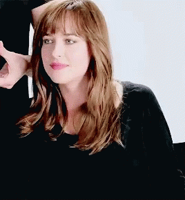 Woman With Long Brown Hair And Bangs In Black Shirt GIF