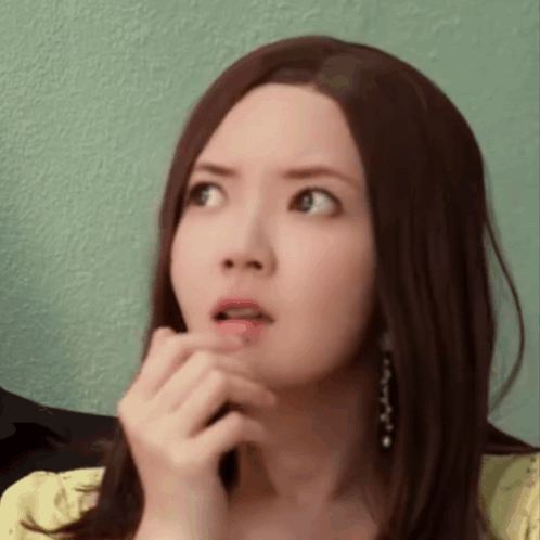 Woman With Long Brown Hair Surprised Hand to Mouth