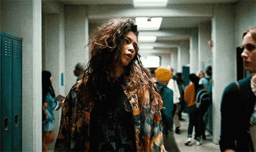 Woman With Long Curly Hair in Hallway With Lockers