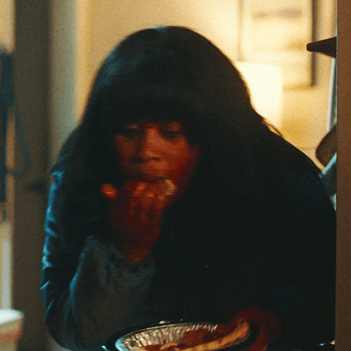 Woman With Long Dark Hair Eating GIF
