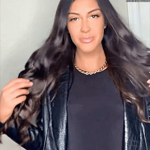 Woman With Long Dark Hair in Black Jacket and Gold Chain
