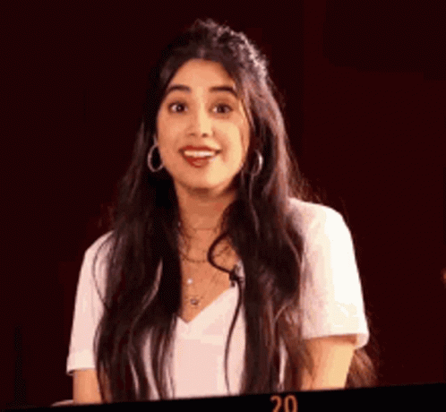 Woman With Long Dark Hair In White Shirt And Earrings GIF