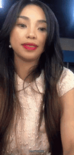 Woman with Long Dark Hair in White Top and Earrings