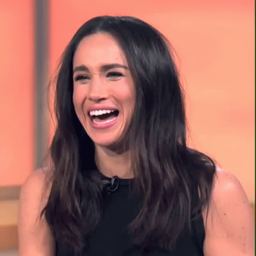 Woman With Long Dark Hair Laughing With Mouth Open