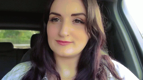 Woman with Long Dark Hair Sitting in Car