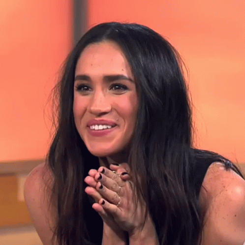 Woman With Long Dark Hair Smiling Hands Folded