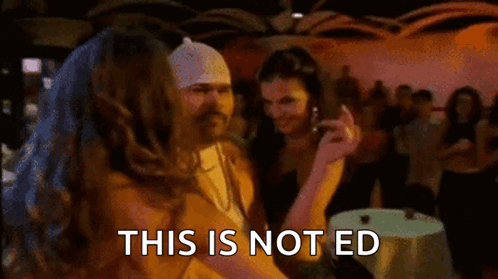 Woman With Long Hair And Arm Tattoo Standing In Hallway GIF