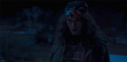 Woman with Long Hair and Bandana in Dark Room