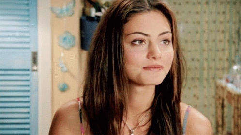 Woman With Long Hair And Necklace Looking At Camera GIF