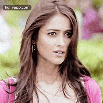 Woman With Long Hair And Pink Sweater Making Funny Face GIF