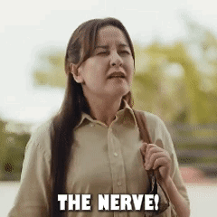 Woman with Long Hair Holding Purse Saying Nerve