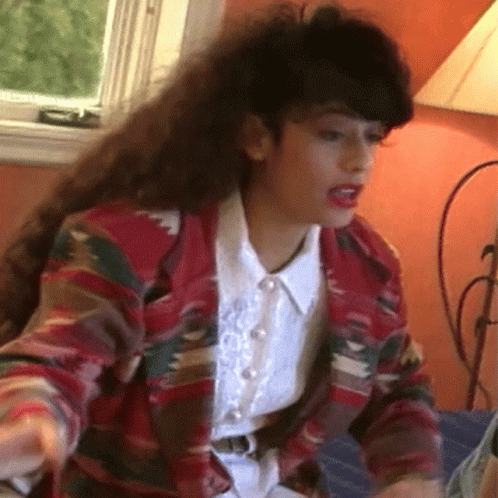 Woman with Long Hair in Colorful Jacket and White Shirt