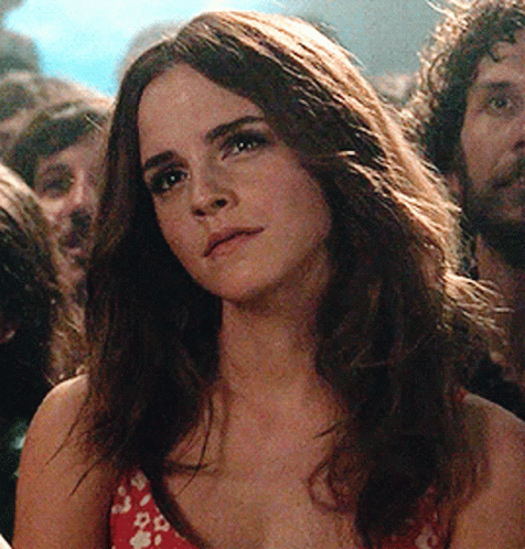 Woman With Long Hair in Crowd Looking at Camera