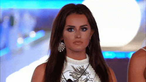 Woman With Long Hair In Earrings And White Top GIF
