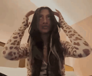 Woman With Long Hair in Leopard Print Sweater Holding Head
