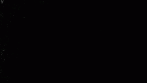 Woman With Long Hair Laying on Stomach in Dark Room