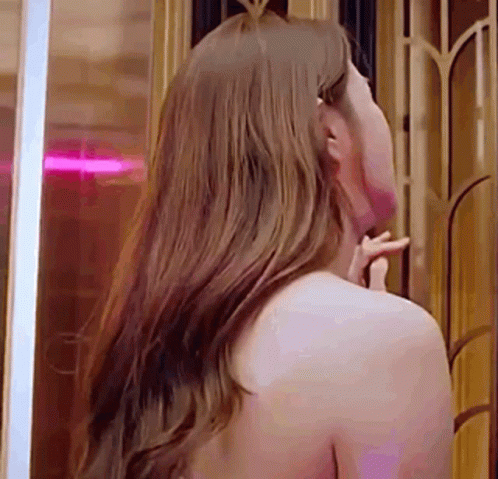 Woman with Long Hair Looking in Mirror