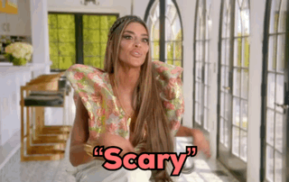 Woman With Long Hair Sitting In Front Of Window Saying Scary GIF