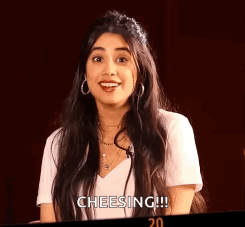 Woman With Long Hair White Shirt and Earrings Smiling