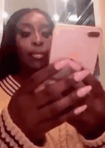 Woman with Long Nails Taking Selfie