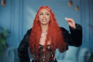 Woman With Long Red Hair In Black Jacket GIF