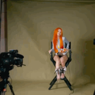 Woman with Long Red Hair Sitting in Director's Chair