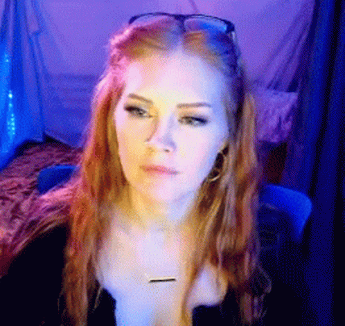 Woman With Long Red Hair Sunglasses and Necklace