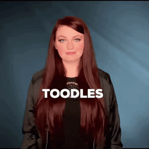 Woman With Long Red Hair Wearing Black Jacket Saying Toodles