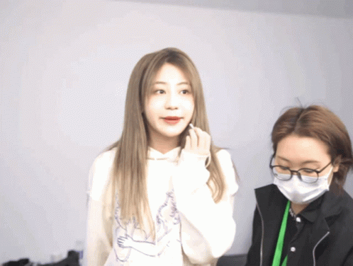 Woman With Mask And Glasses Next To Woman In Hoodie GIF