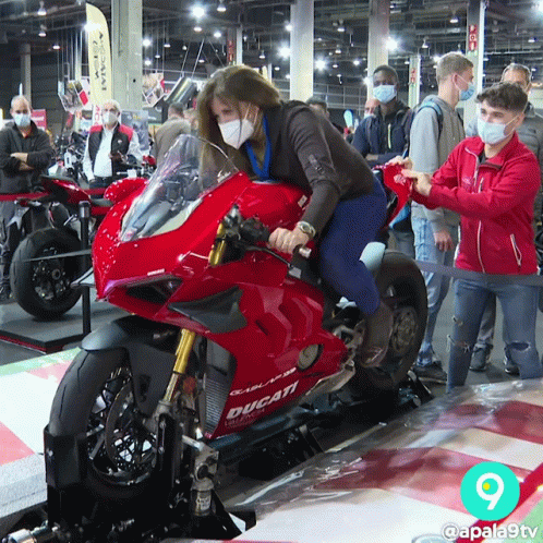 Woman With Mask on Ducati Motorcycle