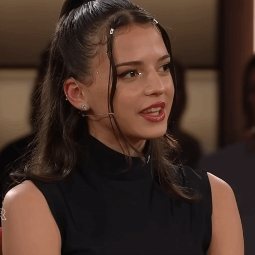 Woman With Microphone In Ear In Black Tank Top GIF