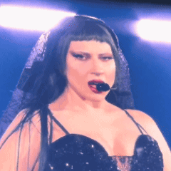 Woman With Microphone in Mouth Black Dress Veil