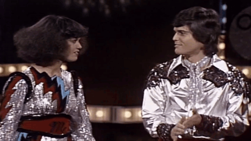 Woman With Mr. Belt Beside Man GIF