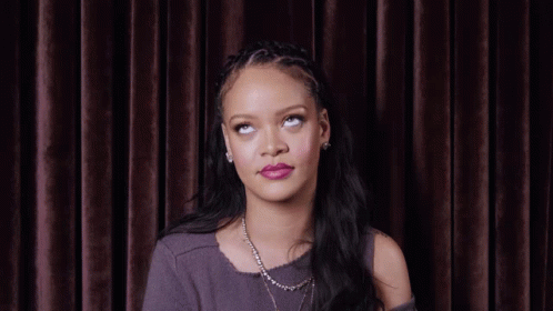 Woman With Necklace And Braided Headband Looking Up GIF
