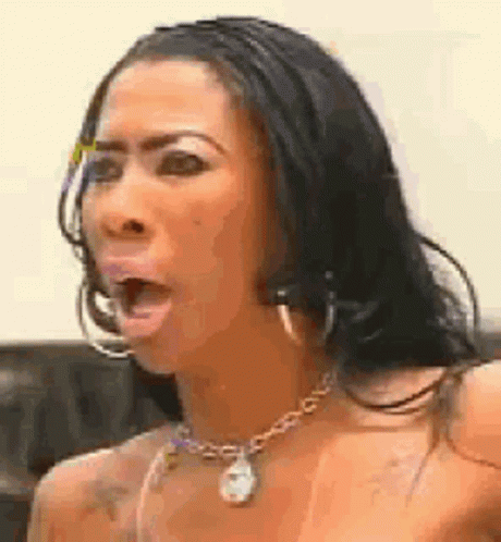 Woman With Necklace and Hoop Earrings Making Funny Face