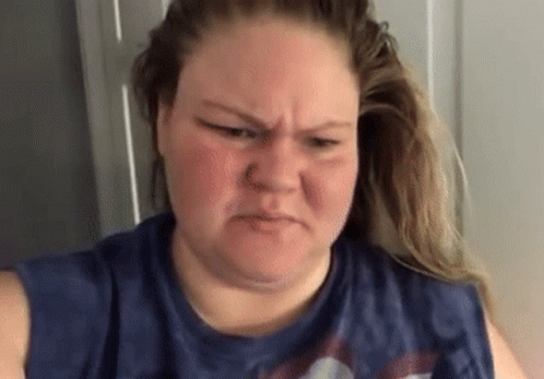 Woman With Nose Ring Making Funny Face In Blue Shirt GIF