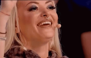 Woman With Nose Ring Smiling and Laughing at Microphone