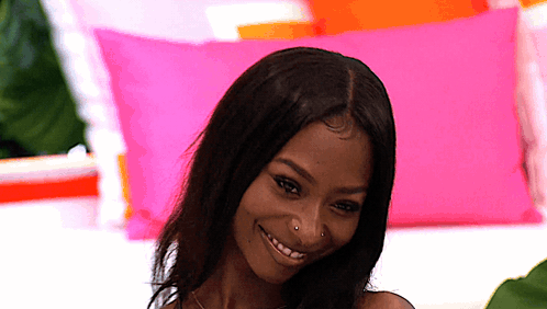 Woman With Nose Ring Smiling With Pink and Orange Pillows