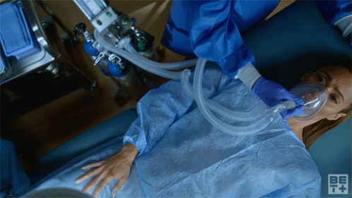 Woman With Oxygen Mask In Hospital Bed GIF