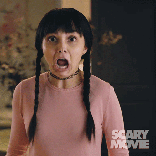 Woman With Pigtails And Choker Surprised By Scary Movie Poster GIF