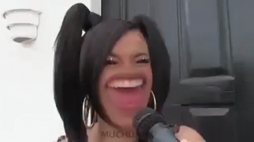 Woman With Pigtails Making Funny Face Holding Microphone GIF