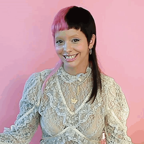 Woman With Pink and Black Hair Smiling in Lace Top