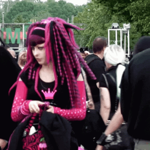 Woman With Pink Dreadlocks Standing in Crowd