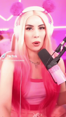 Woman With Pink Hair and Headphones at Pink Microphone