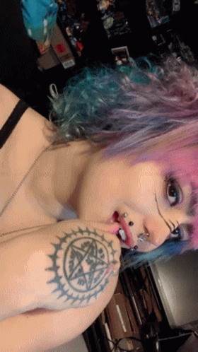 Woman With Pink Hair and Pentagram Tattoo